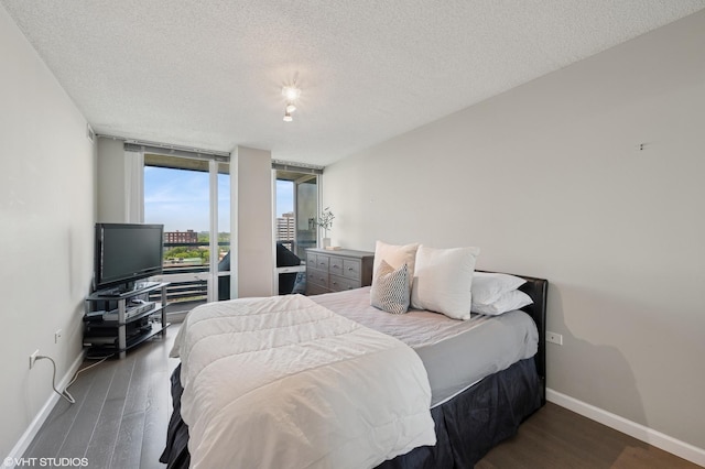 800 Elgin Rd Unit 1406, Evanston, IL 60201 - bedroom featuring a textured ceiling, wood finished floors, and expansive windows
