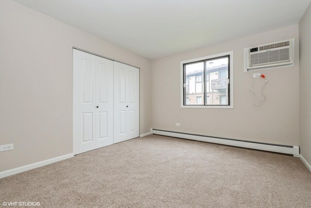 4572 W 131st St Unit 1N, Alsip, IL 60803 - unfurnished bedroom with a baseboard heating unit, carpet, a wall mounted air conditioner, and a closet