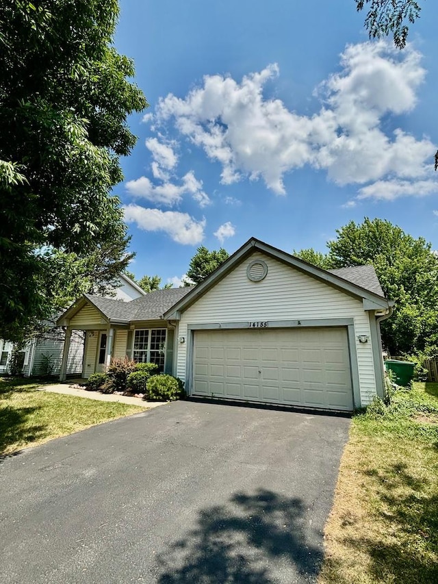 14155 S Hemingway Cir, Plainfield, IL 60544 - ranch-style home featuring driveway, a garage, roof with shingles, and a front lawn