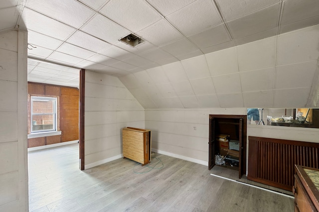 2421 W 21st Pl, Chicago, IL 60608 - additional living space with wood finished floors, vaulted ceiling, and wood walls