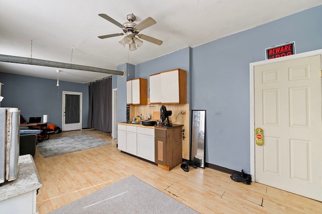 2421 W 21st Pl, Chicago, IL 60608 - kitchen with a ceiling fan, white cabinetry, light wood-style flooring, light countertops, and open floor plan