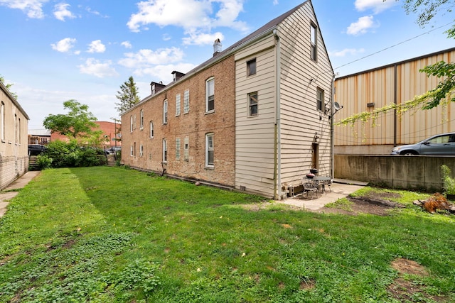 2421 W 21st Pl, Chicago, IL 60608 - rear view of house with a lawn and a patio