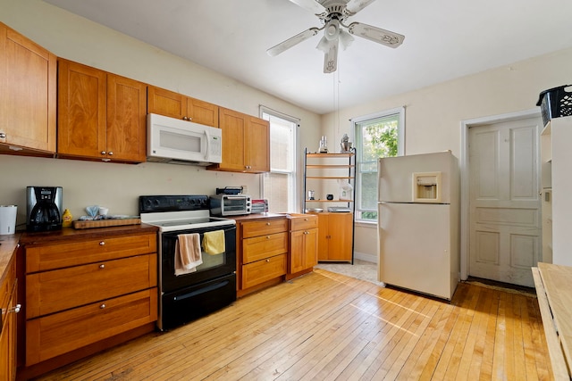 2421 W 21st Pl, Chicago, IL 60608 - kitchen featuring white appliances, light wood-style flooring, brown cabinetry, ceiling fan, and open shelves