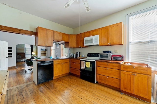 2421 W 21st Pl, Chicago, IL 60608 - kitchen with range with electric cooktop, black dishwasher, white microwave, light wood finished floors, and brown cabinets
