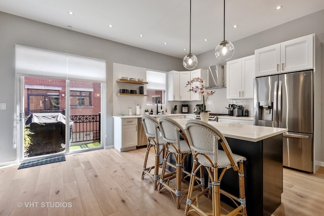 843 W College Pkwy, Chicago, IL 60608 - kitchen with stainless steel refrigerator with ice dispenser, wall chimney exhaust hood, open shelves, light wood-type flooring, and recessed lighting
