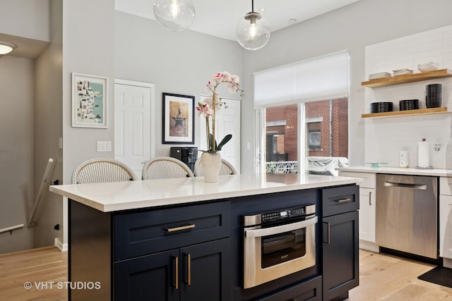 843 W College Pkwy, Chicago, IL 60608 - kitchen with stainless steel appliances, light wood-style flooring, and light countertops