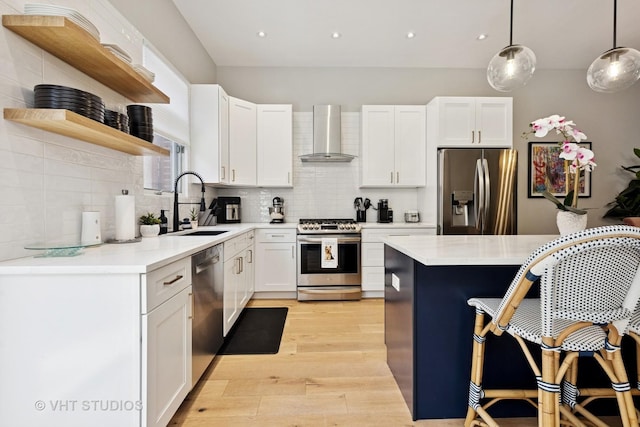843 W College Pkwy, Chicago, IL 60608 - kitchen featuring stainless steel appliances, wall chimney range hood, open shelves, light wood-type flooring, and backsplash