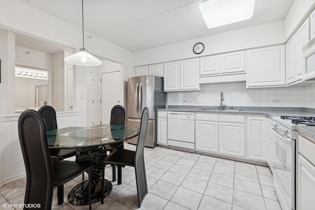 5055 W Madison St Unit 411, Skokie, IL 60077 - kitchen featuring white appliances, decorative backsplash, white cabinetry, and hanging light fixtures