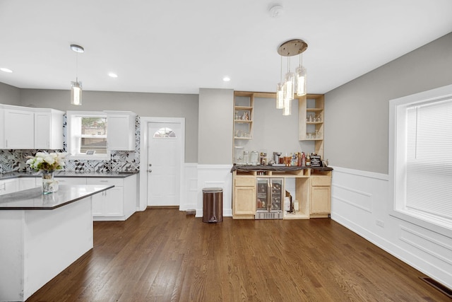 1028 N Lavergne Ave, Chicago, IL 60651 - kitchen with wine cooler, open shelves, dark wood-style floors, wainscoting, and white cabinetry