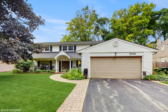 1502 S Fernandez Ave, Arlington Heights, IL 60005 - traditional-style house featuring asphalt driveway, an attached garage, and a porch