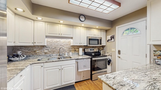1502 S Fernandez Ave, Arlington Heights, IL 60005 - kitchen with appliances with stainless steel finishes, decorative backsplash, white cabinets, light wood-style flooring, and recessed lighting