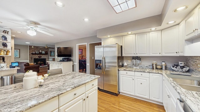 1502 S Fernandez Ave, Arlington Heights, IL 60005 - kitchen featuring stainless steel appliances, a ceiling fan, a brick fireplace, open floor plan, and recessed lighting