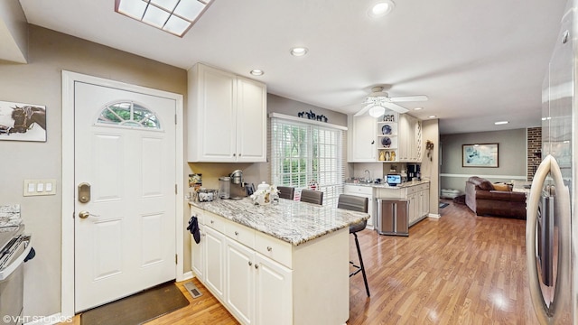 1502 S Fernandez Ave, Arlington Heights, IL 60005 - kitchen featuring light wood finished floors, a breakfast bar, recessed lighting, white cabinetry, and ceiling fan