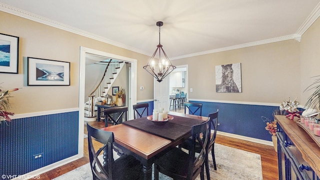 1502 S Fernandez Ave, Arlington Heights, IL 60005 - dining space with a chandelier, stairs, wood finished floors, crown molding, and wainscoting