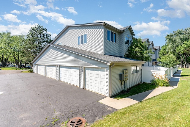 392 Park Ridge Ln Unit B, Aurora, IL 60504 - view of side of home with asphalt driveway and roof with shingles