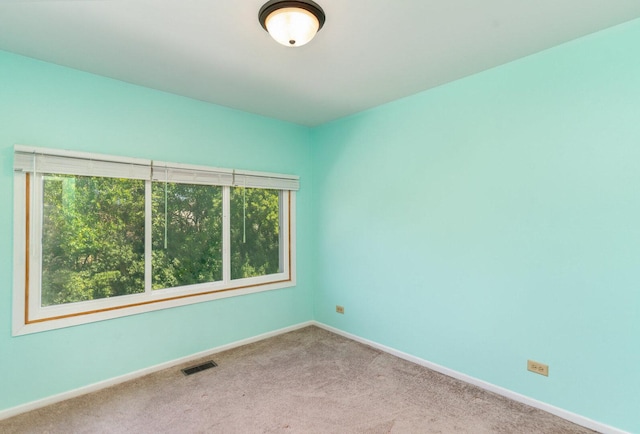 392 Park Ridge Ln Unit B, Aurora, IL 60504 - spare room featuring baseboards and carpet