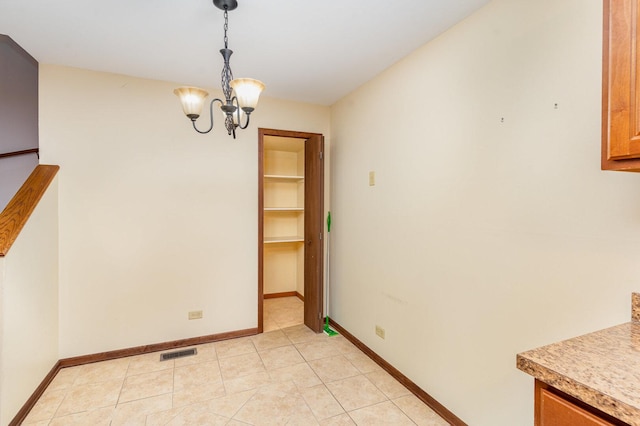 392 Park Ridge Ln Unit B, Aurora, IL 60504 - unfurnished dining area featuring a chandelier and light tile patterned floors