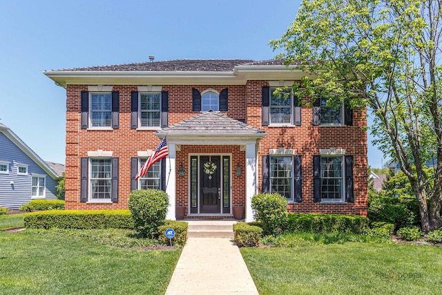 870 Symphony St, Lake Forest, IL 60045 - colonial house featuring a front yard and brick siding