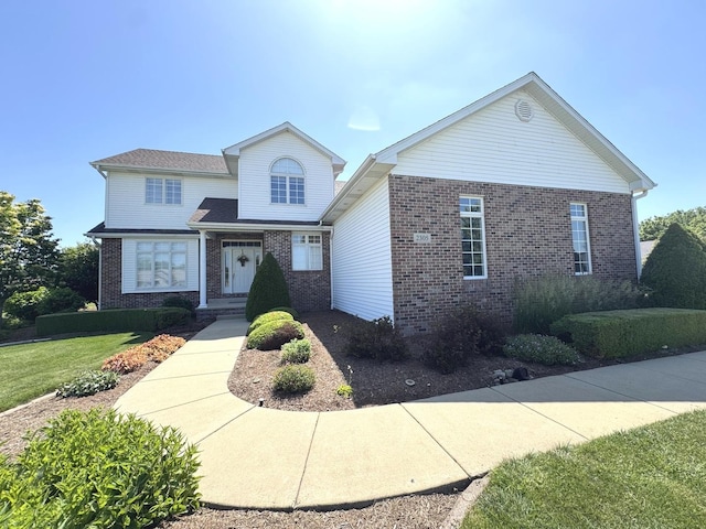2305 Fox Run Dr, Kankakee, IL 60901 - traditional-style house with brick siding and a front lawn