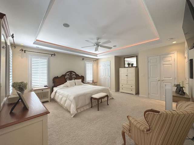 2305 Fox Run Dr, Kankakee, IL 60901 - bedroom featuring a raised ceiling, light carpet, two closets, and a ceiling fan