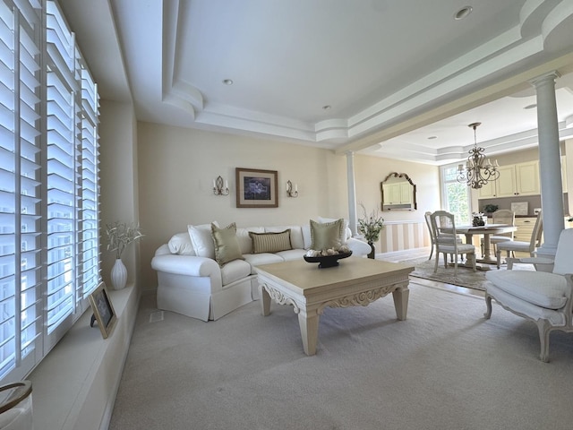 2305 Fox Run Dr, Kankakee, IL 60901 - living area with a tray ceiling, carpet floors, ornate columns, and a chandelier