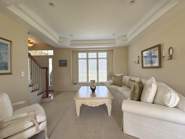 2305 Fox Run Dr, Kankakee, IL 60901 - living area featuring light colored carpet, a tray ceiling, and stairway