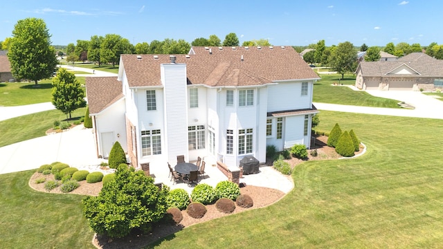 2305 Fox Run Dr, Kankakee, IL 60901 - back of property with a chimney, a patio, and a yard