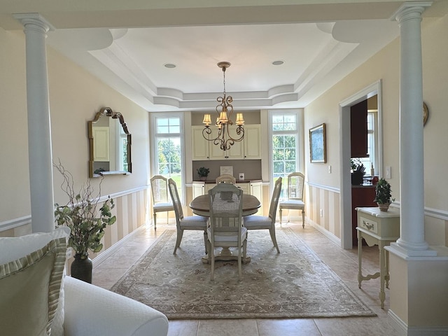 2305 Fox Run Dr, Kankakee, IL 60901 - dining space with a raised ceiling, ornate columns, a chandelier, and wainscoting