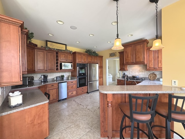 2305 Fox Run Dr, Kankakee, IL 60901 - kitchen with appliances with stainless steel finishes, backsplash, a peninsula, recessed lighting, and light tile patterned floors