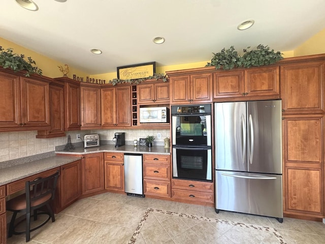 2305 Fox Run Dr, Kankakee, IL 60901 - kitchen with freestanding refrigerator, built in microwave, brown cabinets, fridge, and recessed lighting