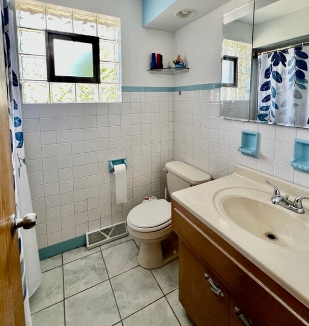 6359 W 63rd Pl, Chicago, IL 60638 - bathroom with vanity, tile walls, tile patterned flooring, a shower with curtain, and a wainscoted wall