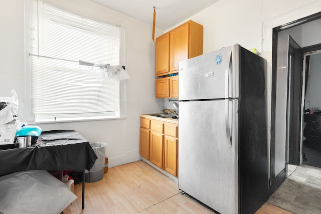 15 N Washtenaw Ave, Chicago, IL 60612 - kitchen featuring freestanding refrigerator, light wood finished floors, plenty of natural light, and light countertops