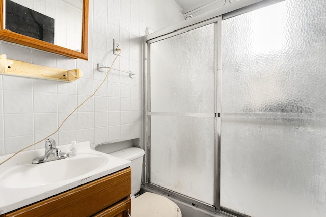 15 N Washtenaw Ave, Chicago, IL 60612 - bathroom with tile walls, a shower with door, vanity, and tasteful backsplash