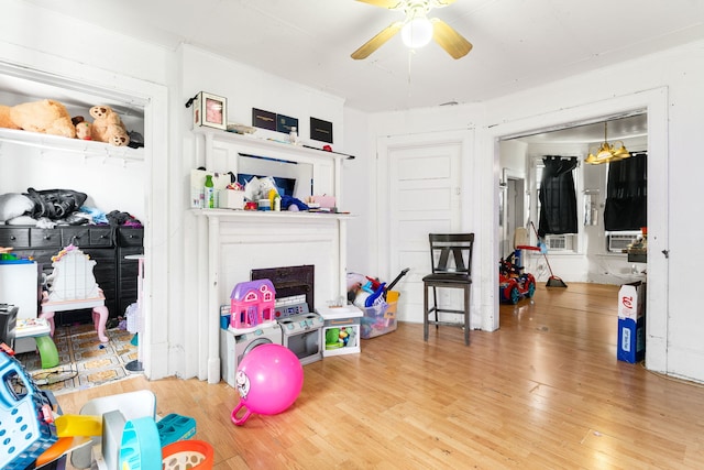 15 N Washtenaw Ave, Chicago, IL 60612 - rec room with a ceiling fan, wood finished floors, and a fireplace