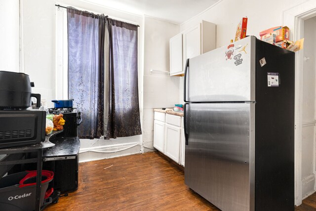 15 N Washtenaw Ave, Chicago, IL 60612 - kitchen featuring freestanding refrigerator, white cabinets, dark wood-style floors, and light countertops