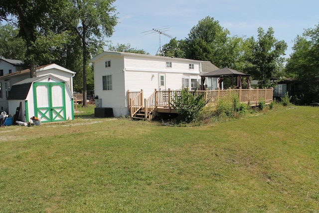 183 Fossil Cove Ct, Wilmington, IL 60481 - back of house featuring a gazebo, a storage shed, a wooden deck, and a yard