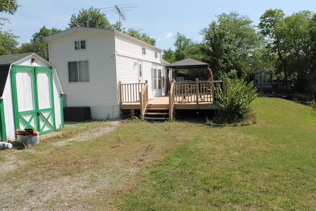 183 Fossil Cove Ct, Wilmington, IL 60481 - back of house with a gazebo, a storage shed, a wooden deck, and a lawn