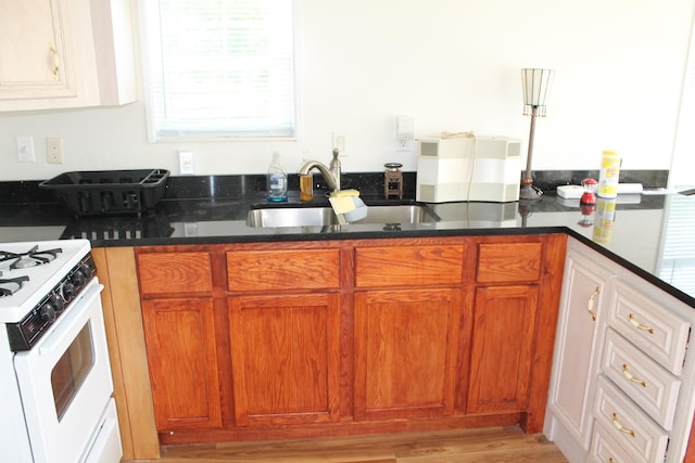 183 Fossil Cove Ct, Wilmington, IL 60481 - kitchen featuring white gas range, brown cabinetry, and dark stone countertops