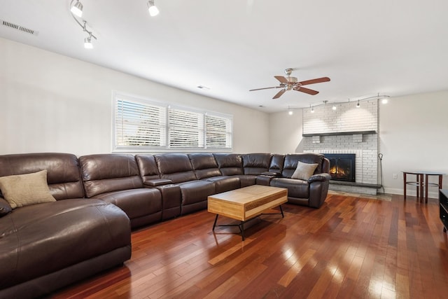 12133 Black Pine Trl, Homer Glen, IL 60491 - living room featuring rail lighting, a ceiling fan, hardwood / wood-style floors, and a fireplace