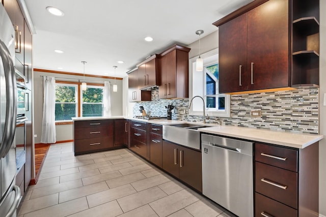 12133 Black Pine Trl, Homer Glen, IL 60491 - kitchen with appliances with stainless steel finishes, a peninsula, tasteful backsplash, hanging light fixtures, and recessed lighting
