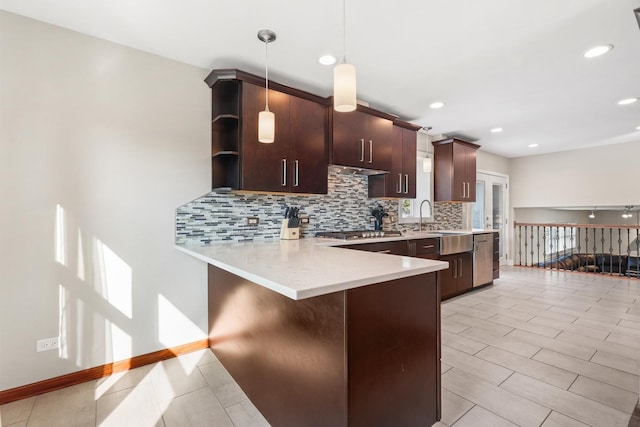 12133 Black Pine Trl, Homer Glen, IL 60491 - kitchen with tasteful backsplash, light countertops, a peninsula, a breakfast bar area, and dark brown cabinets