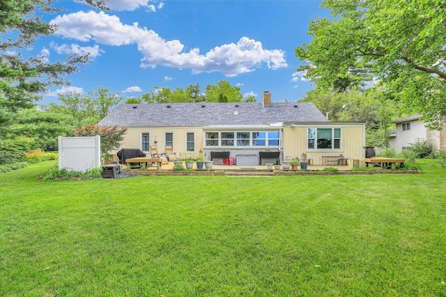 201 E Sherwin Dr, Urbana, IL 61802 - rear view of property with a patio, a lawn, and a chimney