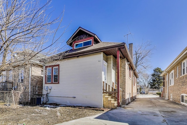 8914 S Throop St, Chicago, IL 60620 - view of side of home featuring driveway and a chimney