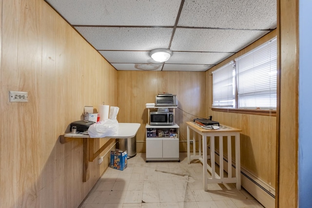1336 Cuyler Ave, Berwyn, IL 60402 - kitchen featuring stainless steel microwave, a drop ceiling, a baseboard heating unit, wooden walls, and light flooring