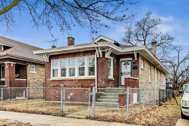 10510 S State St, Chicago, IL 60628 - view of front of property with a chimney, brick siding, a gate, and a fenced front yard