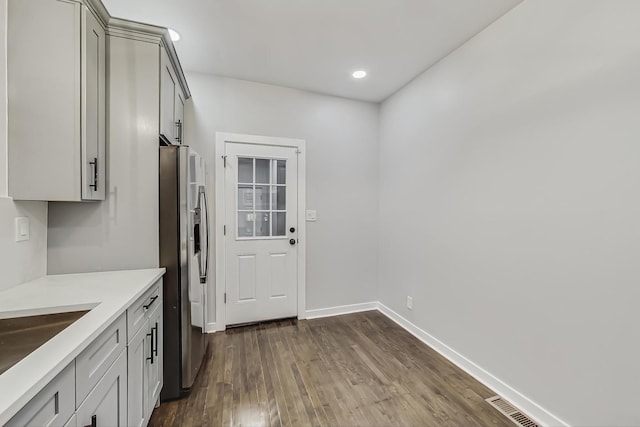 10510 S State St, Chicago, IL 60628 - kitchen with stainless steel refrigerator with ice dispenser, dark wood-style floors, light countertops, gray cabinetry, and recessed lighting