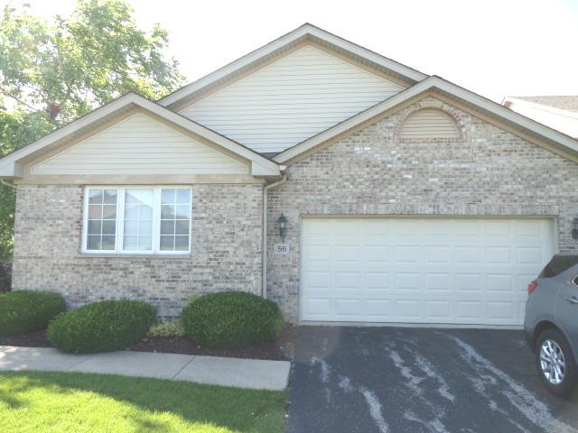 ranch-style home with asphalt driveway, a garage, and brick siding