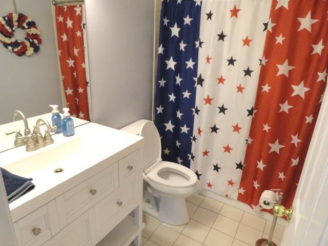 bathroom with vanity, tile patterned flooring, and curtained shower