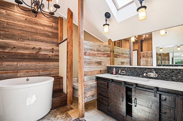 30 S Slusser St, Grayslake, IL 60030 - bathroom featuring a chandelier, wood walls, a freestanding tub, vanity, and a skylight