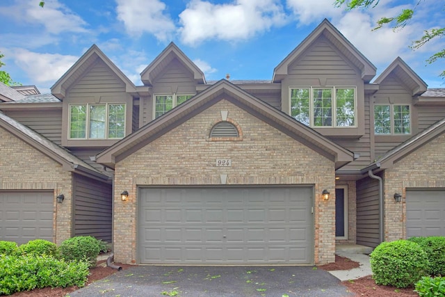 924 Millcreek Cir, Elgin, IL 60123 - craftsman-style house featuring driveway and brick siding
